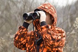 Hunter looking through binoculars