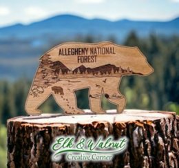 Black cherry wood carving of a black bear with magnet on back