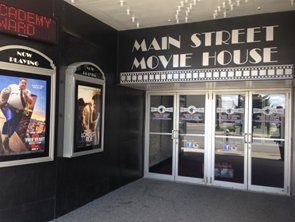 Theater entryway with movie posters on the walls