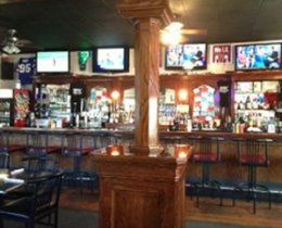 Interior view showing tables, bar and big screen TVs