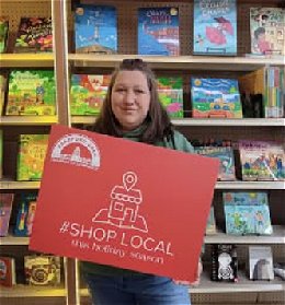 Store owner Heather Whittemore in front of book display