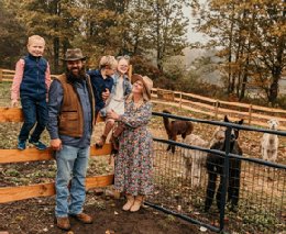Family in front of alpaca coral